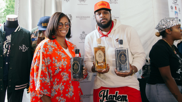 Sharene Wood (L) poses with two liquors from her “Bespoke Spirits” line at Harlem Eat Up